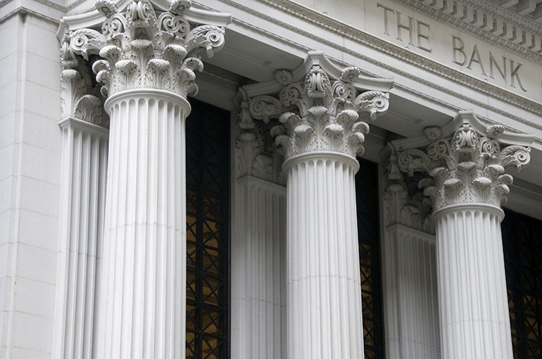 Large stone columns of central bank with ornate design at the top